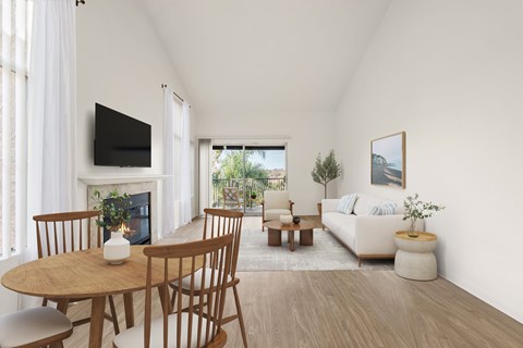 A living room with a fireplace, a TV, a couch, a coffee table, and a dining table.