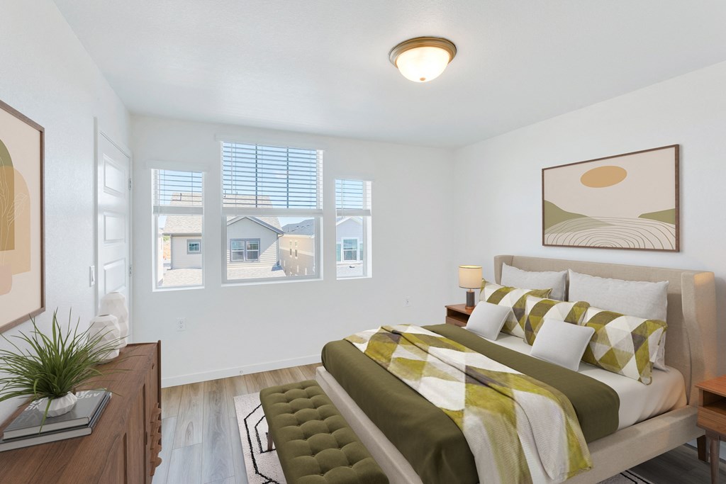 a bedroom with a large bed and a window