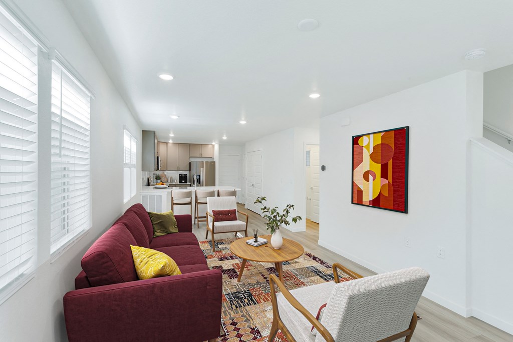 a living room with a red couch and a table