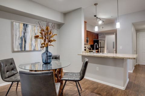 A dining room with a glass table and chairs.