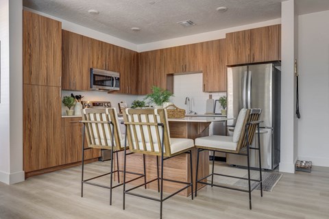 a kitchen with a table and chairs and a refrigerator