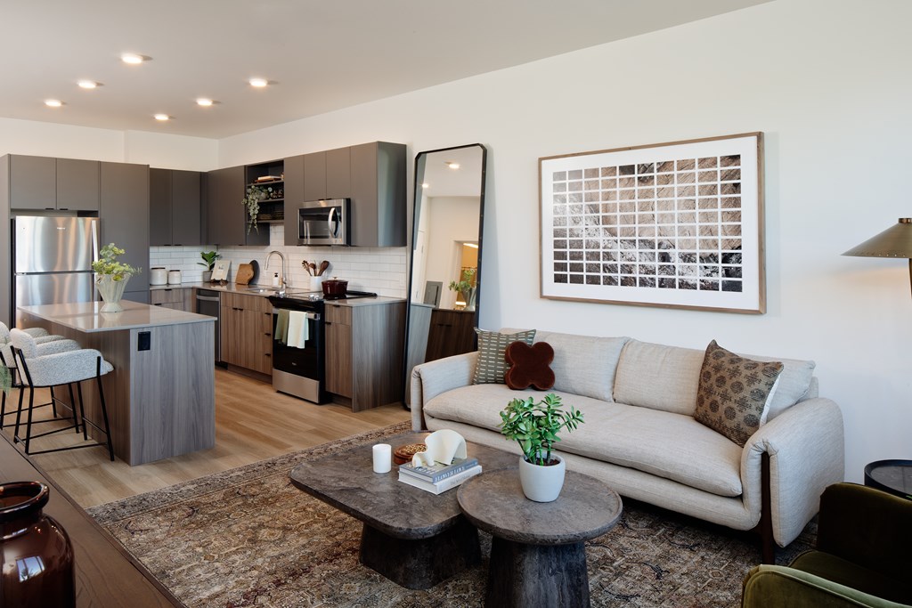 A modern kitchen with a dining table and a couch.
