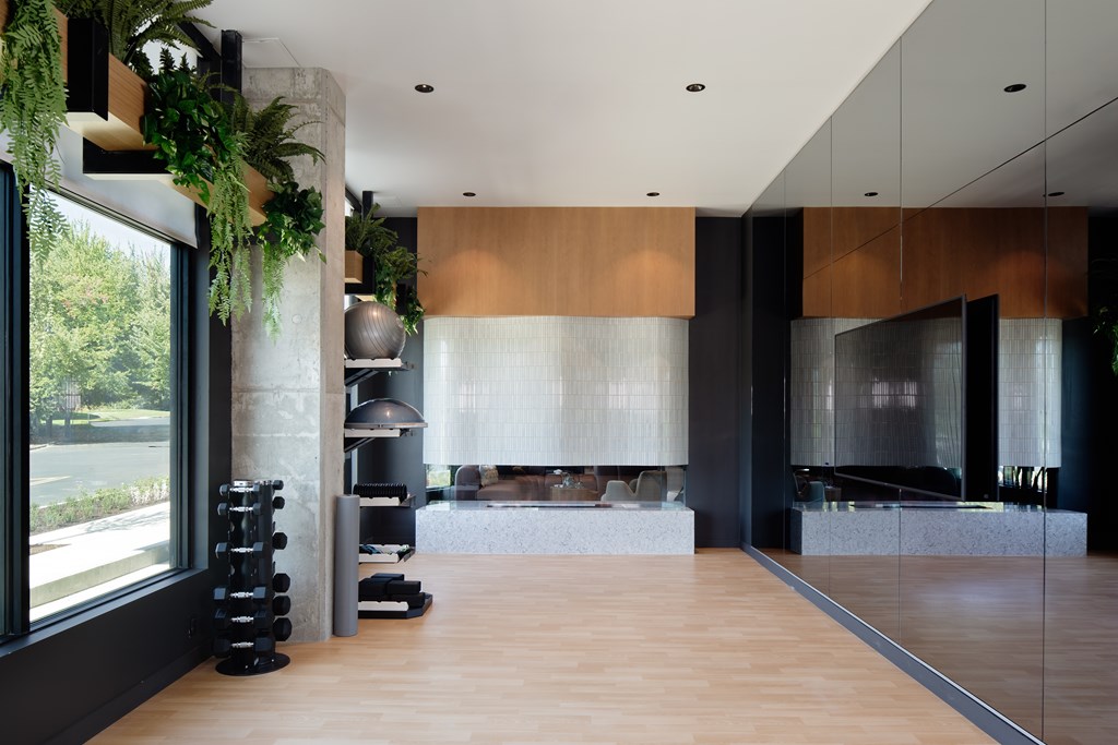 A modern living room with a large window and a wooden floor.