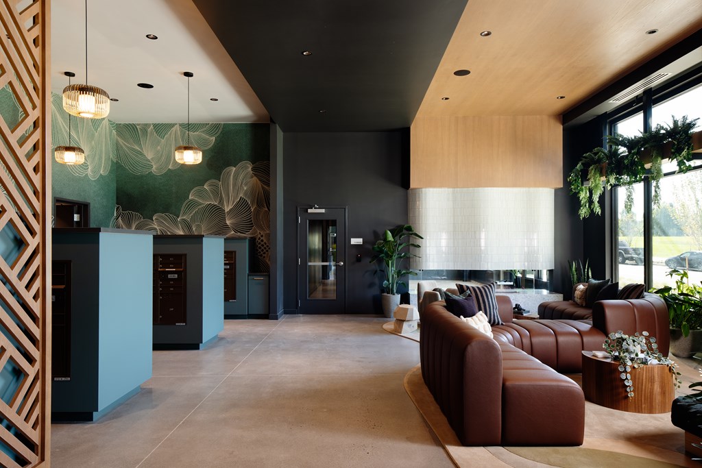 A modern living room with a brown leather couch and a wooden coffee table.