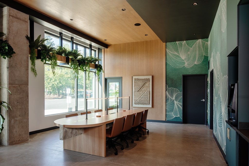 A conference room with a long table and chairs.