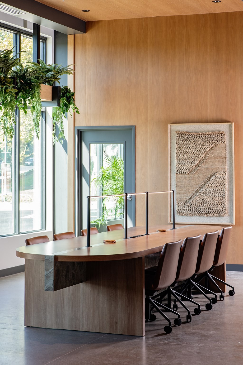 A conference room with a long table and chairs.