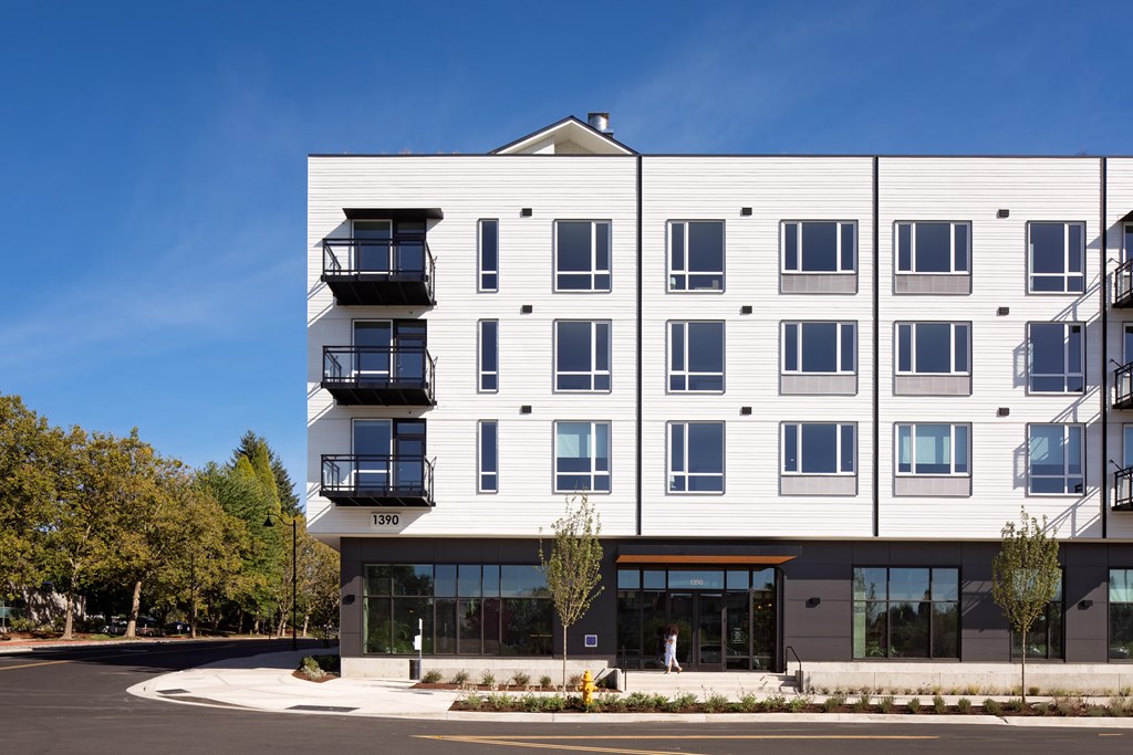 A modern building with a balcony on the second floor.