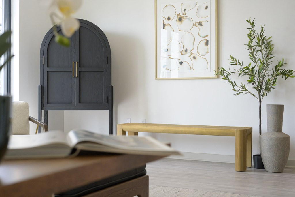 a living room with a table and a chair and a window