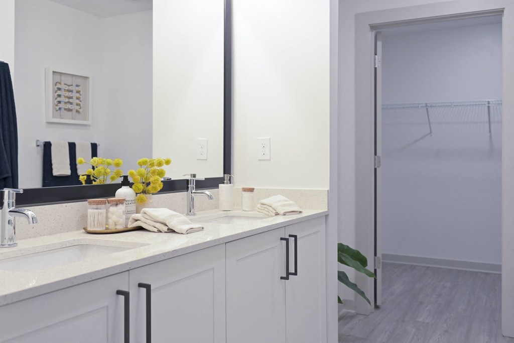 a white bathroom with a sink and a mirror