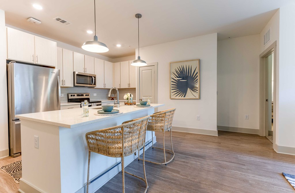 a kitchen with an island and three stools