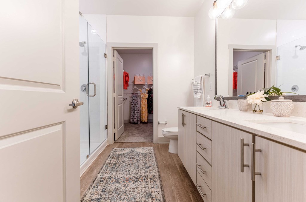 a bathroom with white cabinets and a white toilet