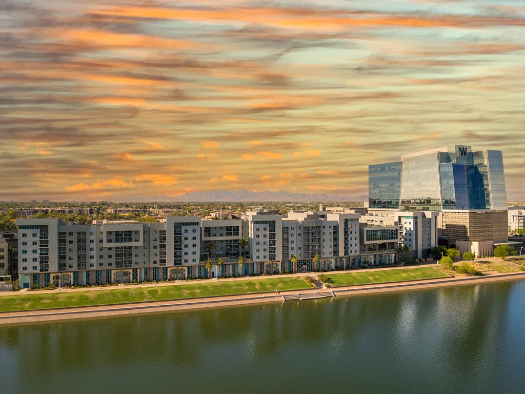 a city skyline with a river in the foreground
