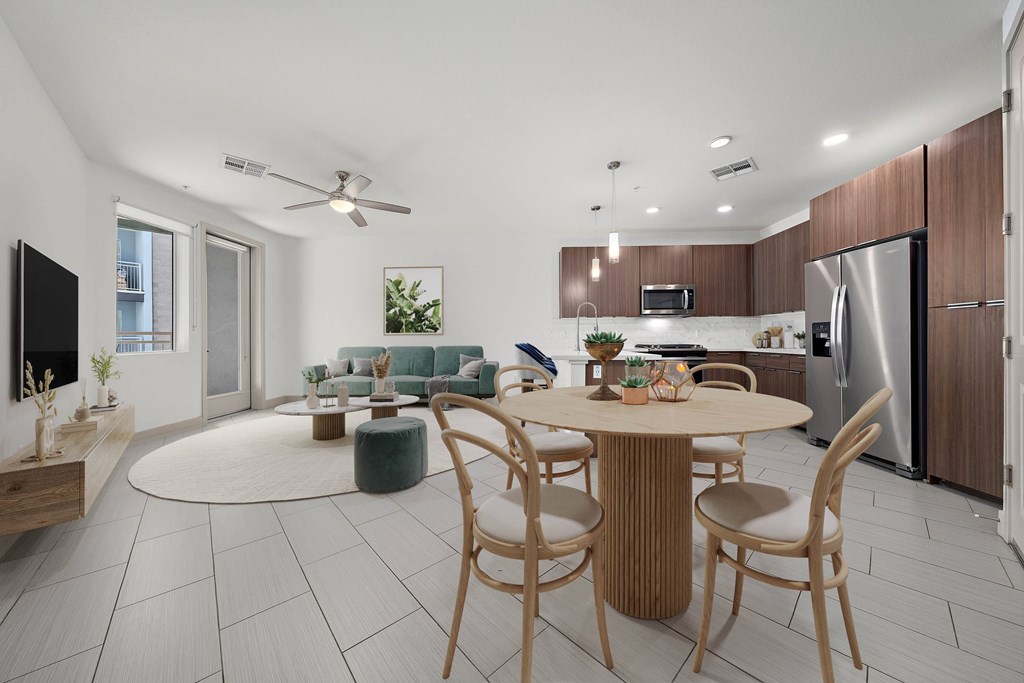 A modern kitchen with a dining table and chairs.