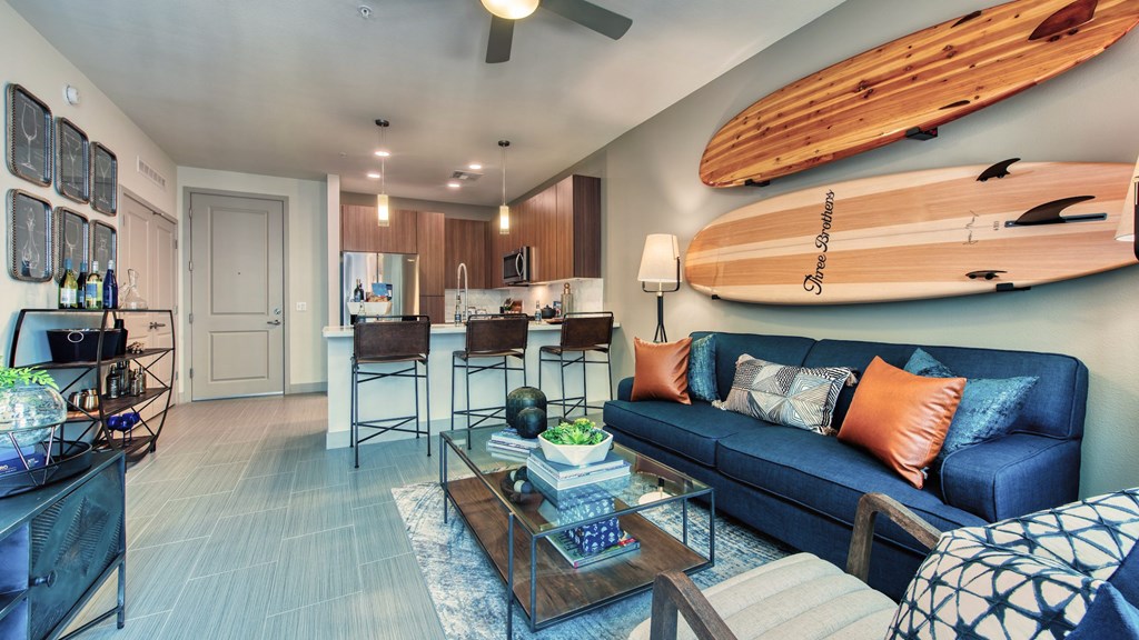 A living room with a blue couch and a wooden coffee table.