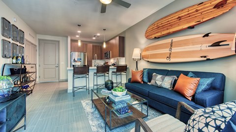 A living room with a blue couch and a wooden coffee table.