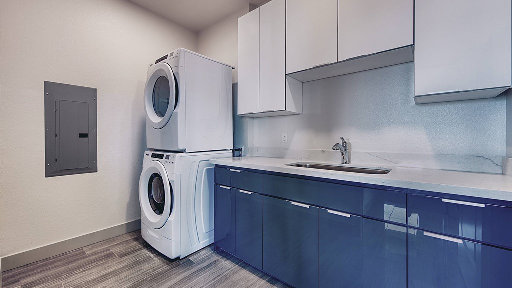 A washing machine is placed in a laundry room.