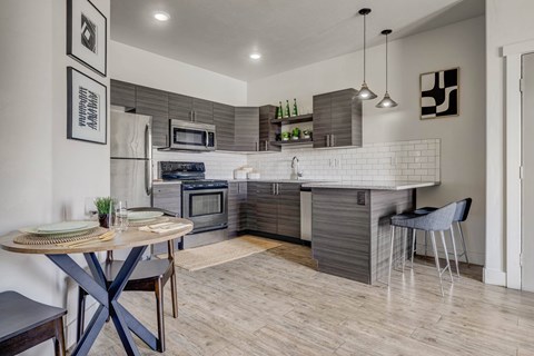 A modern kitchen with a dining table and chairs.