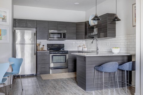 a kitchen with stainless steel appliances and a counter