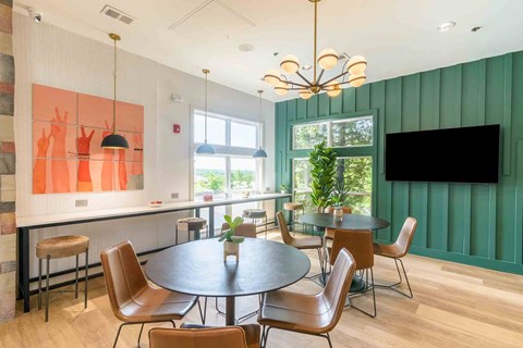 A modern dining room with a round table and chairs.