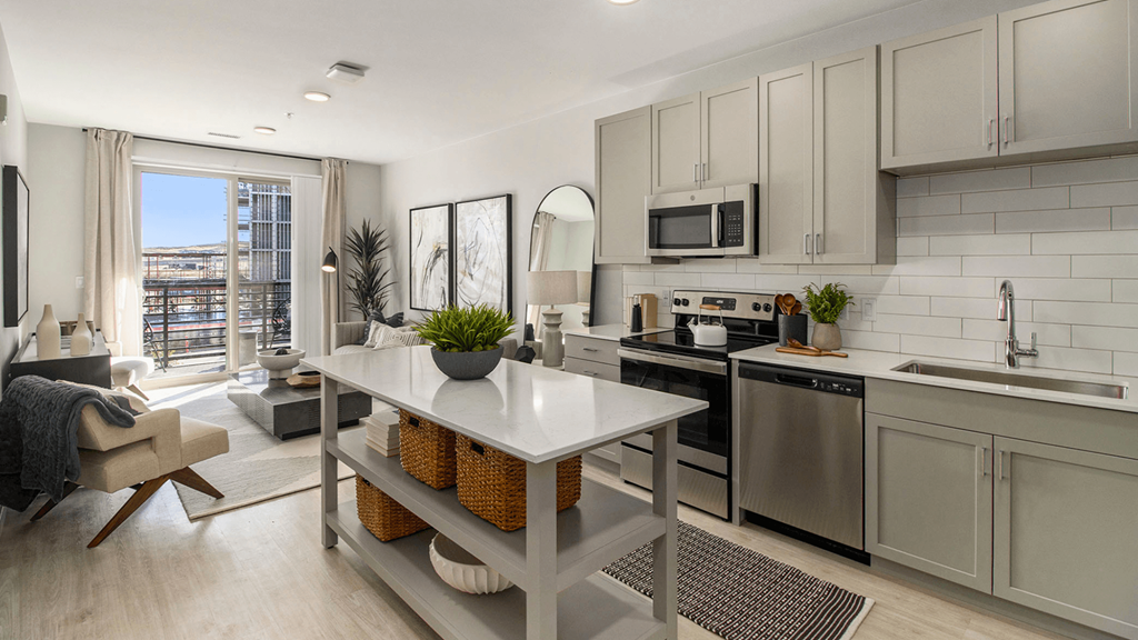 a kitchen with stainless steel appliances and a white table