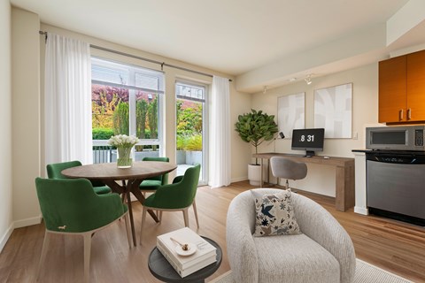A modern living room with a dining table and chairs.