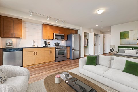 A modern kitchen with wooden cabinets and stainless steel appliances.