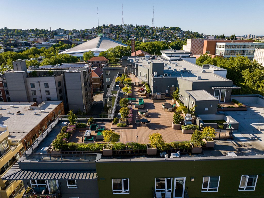 an aerial view of a large city with trees and rooftops  at Axis, Washington, 98109