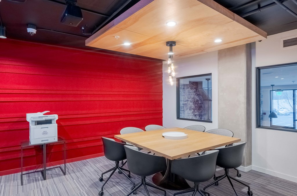 A conference room with a wooden table and chairs.at Axle, Seattle Washington