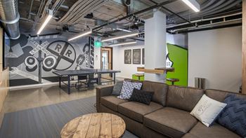A room with a brown couch and a wooden table.at Axle, Washington