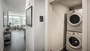 A washer and dryer stacked on top of each other in a small room.at Axle, Seattle, 98119