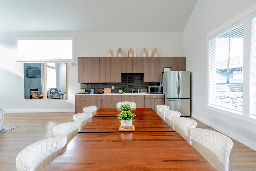 a large dining room with a wooden table and chairs