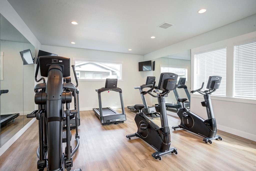 gym with exercise equipment in a room with windows