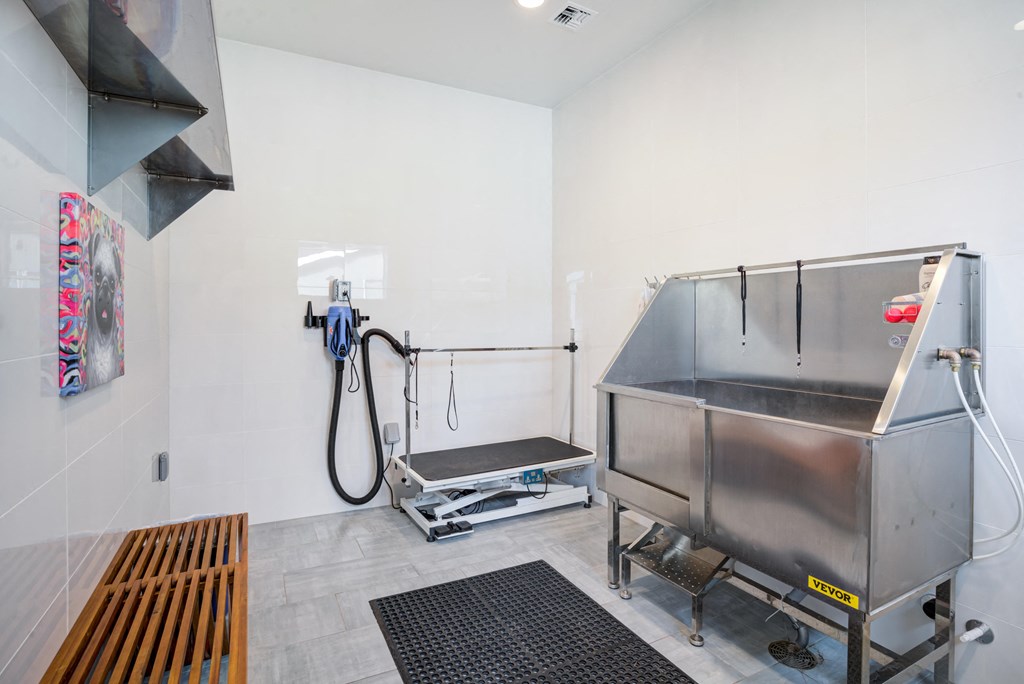 a commercial kitchen with a sink and a large metal container