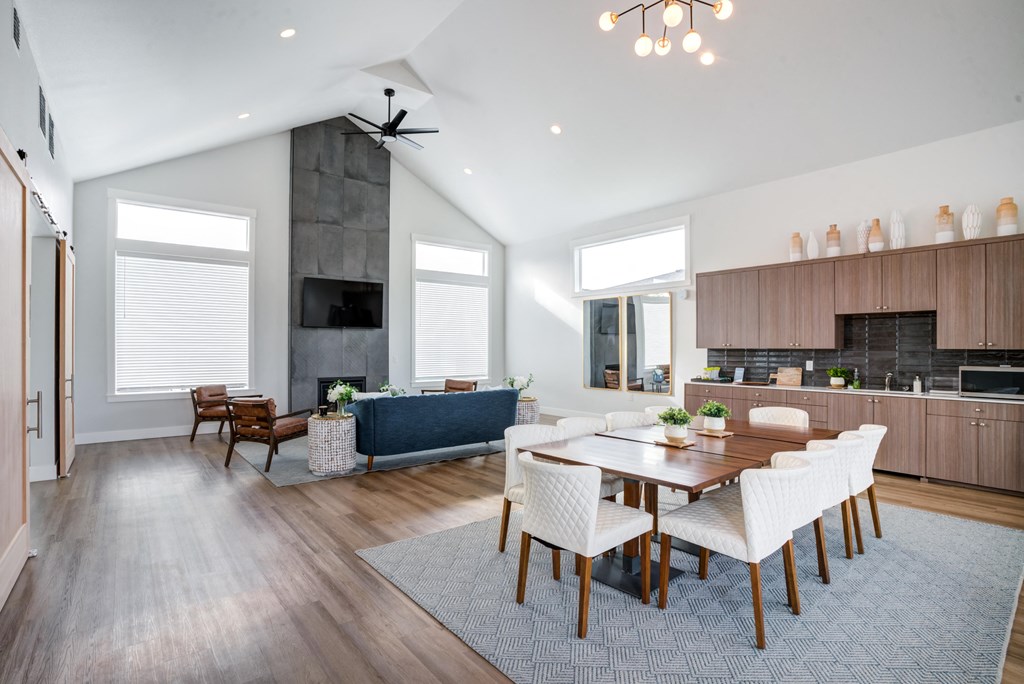 a living room and dining room with a table and chairs
