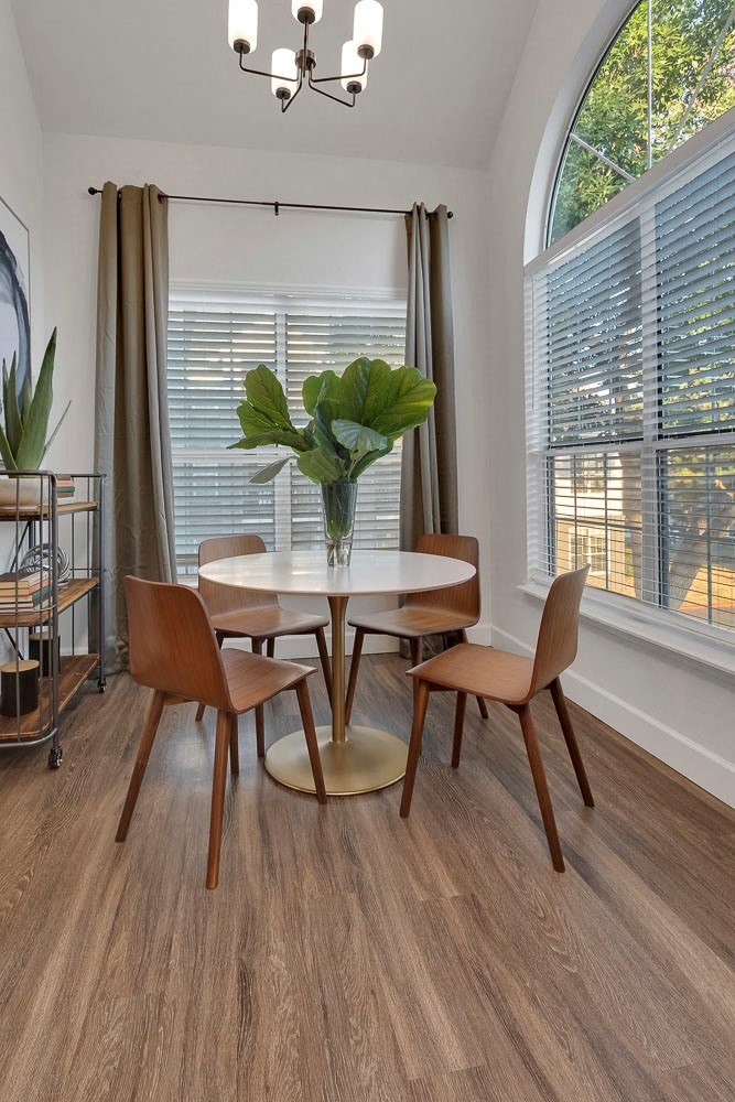 A dining room with a round table and chairs.