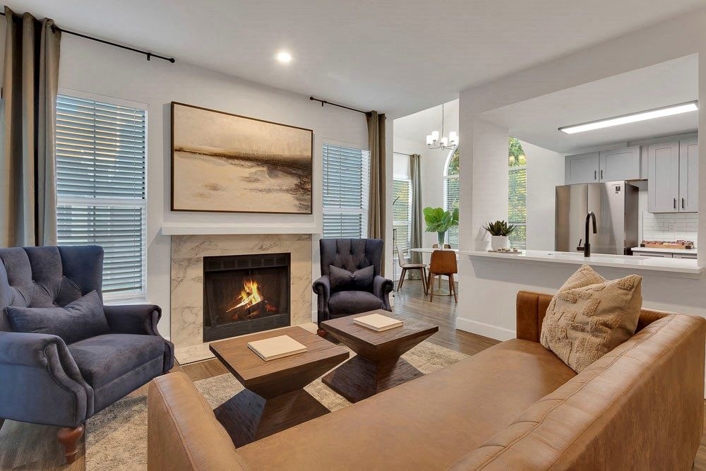 A living room with a fireplace and a painting on the wall.