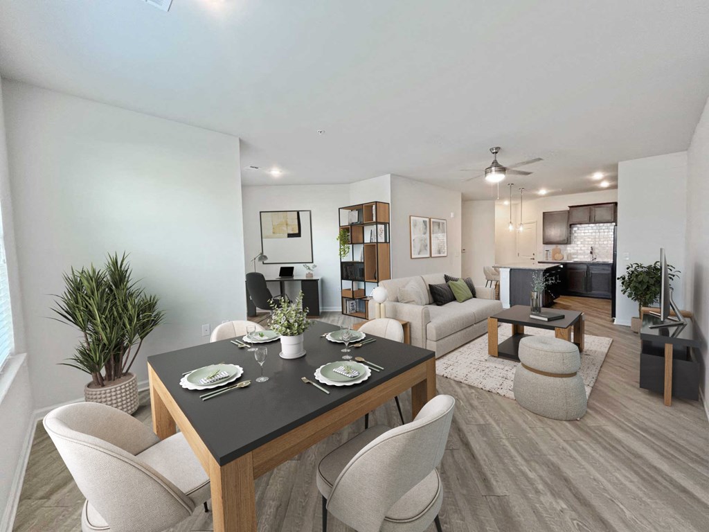A dining room with a black table and white chairs.