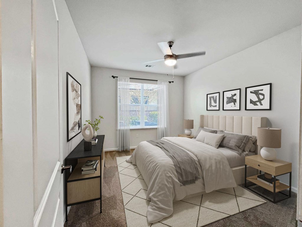 A bedroom with a large bed and a ceiling fan.