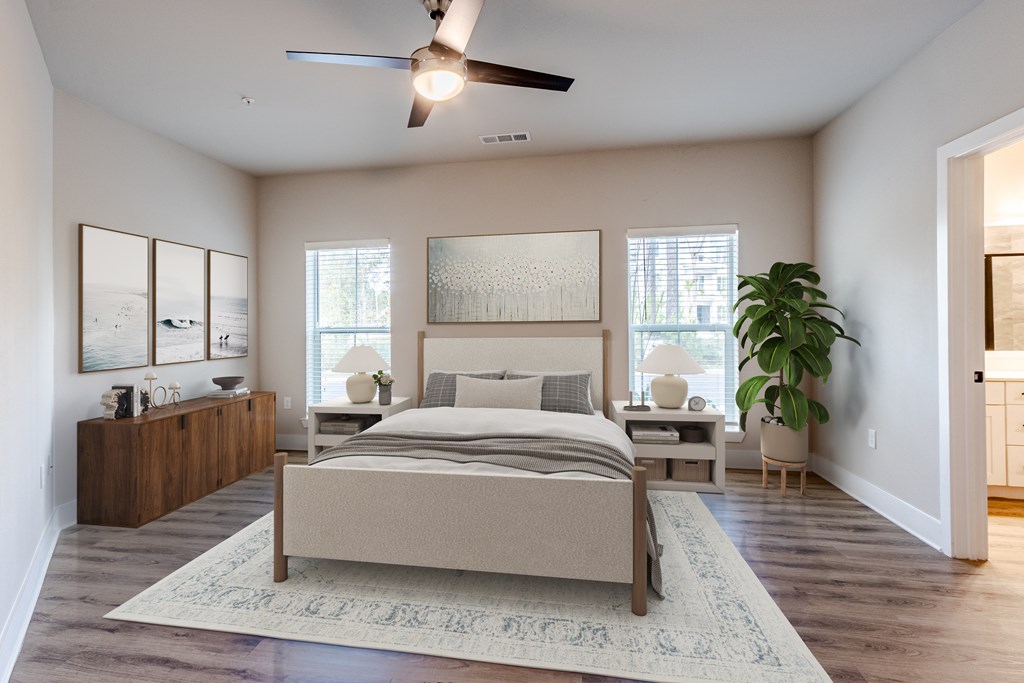 A bedroom with a large bed and a ceiling fan.