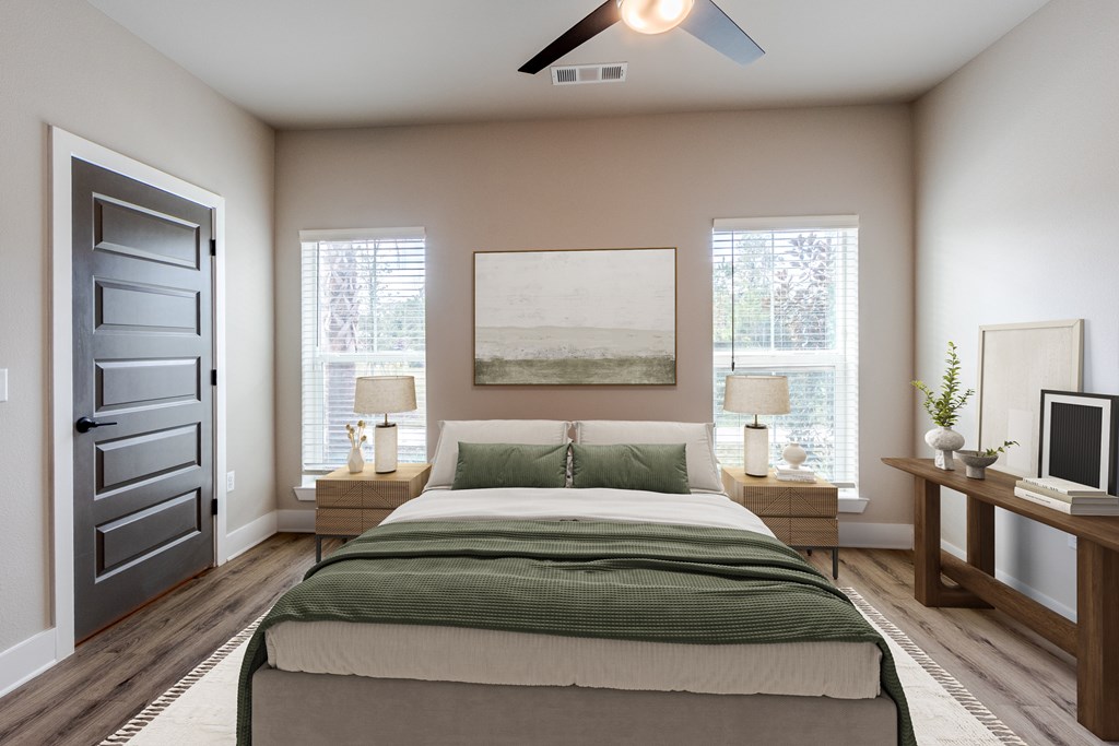 A bedroom with a bed, nightstands, and a ceiling fan.