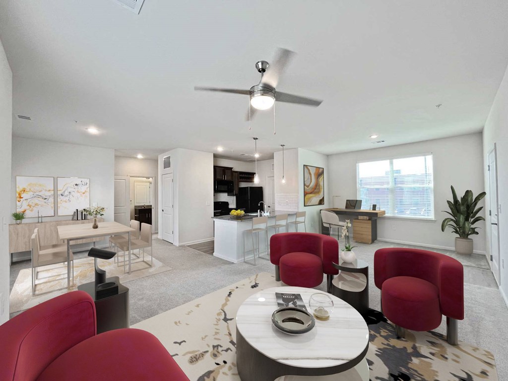 A modern living room with a dining area and kitchen in the background.