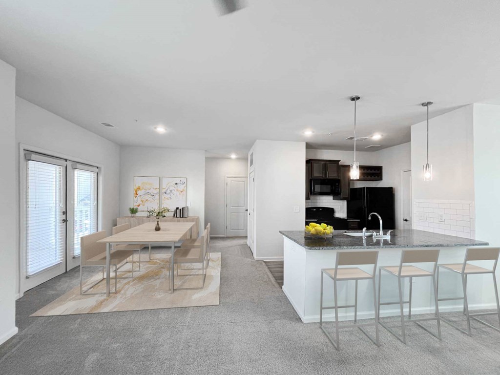A modern kitchen with a dining table and chairs.