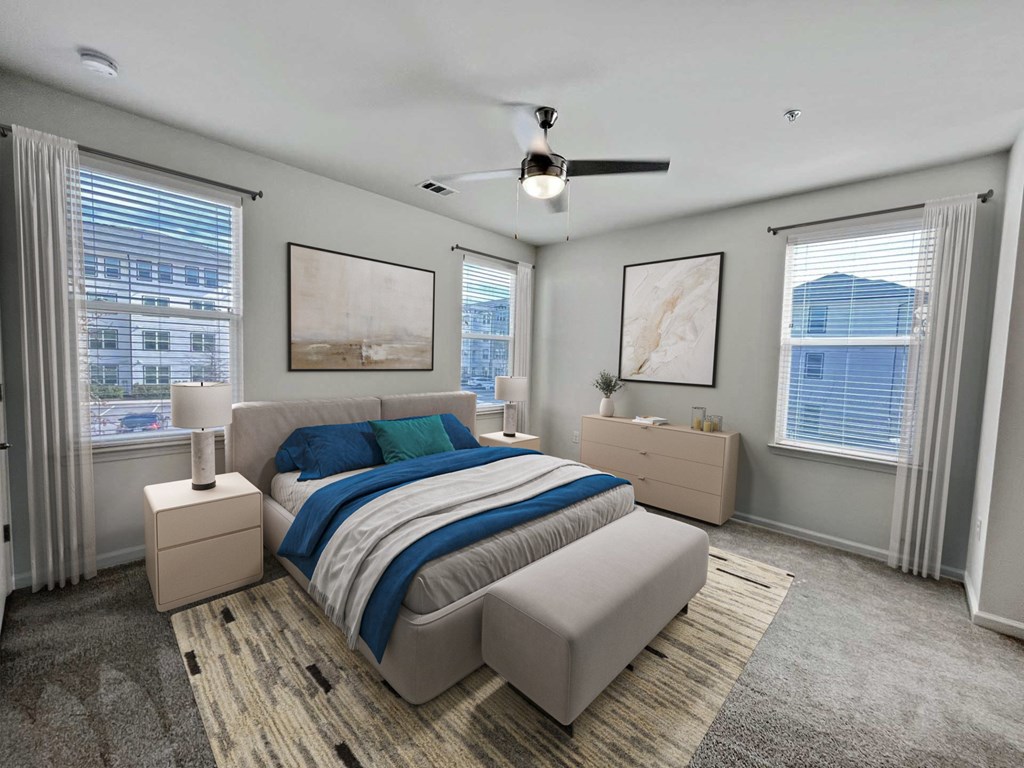 A bedroom with a large bed and a ceiling fan.