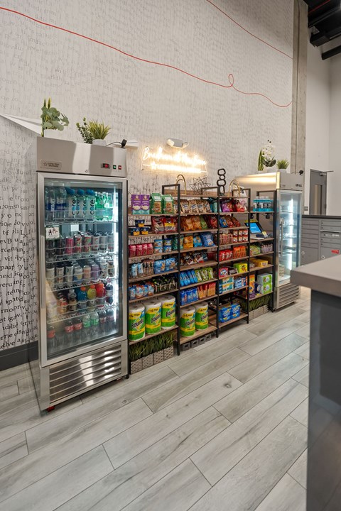 A wall of drinks and snacks in a cooler.