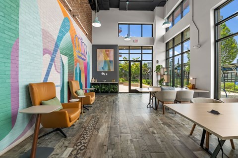 A room with a mural on the wall and a wooden floor.