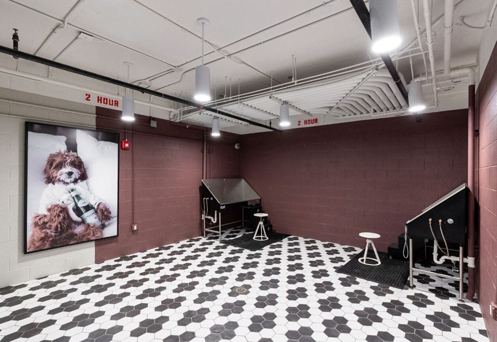 a large room with a black and white tile floor and a large poster of a