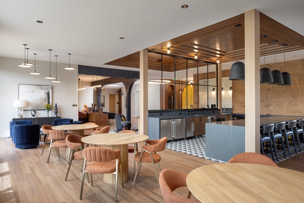 A modern dining room with a wooden table and chairs.
