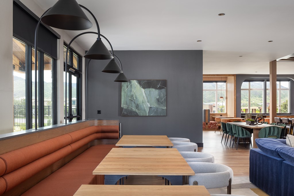 A modern room with a long table and chairs.
