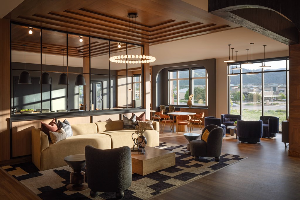 A modern living room with a large window and a view of the city.