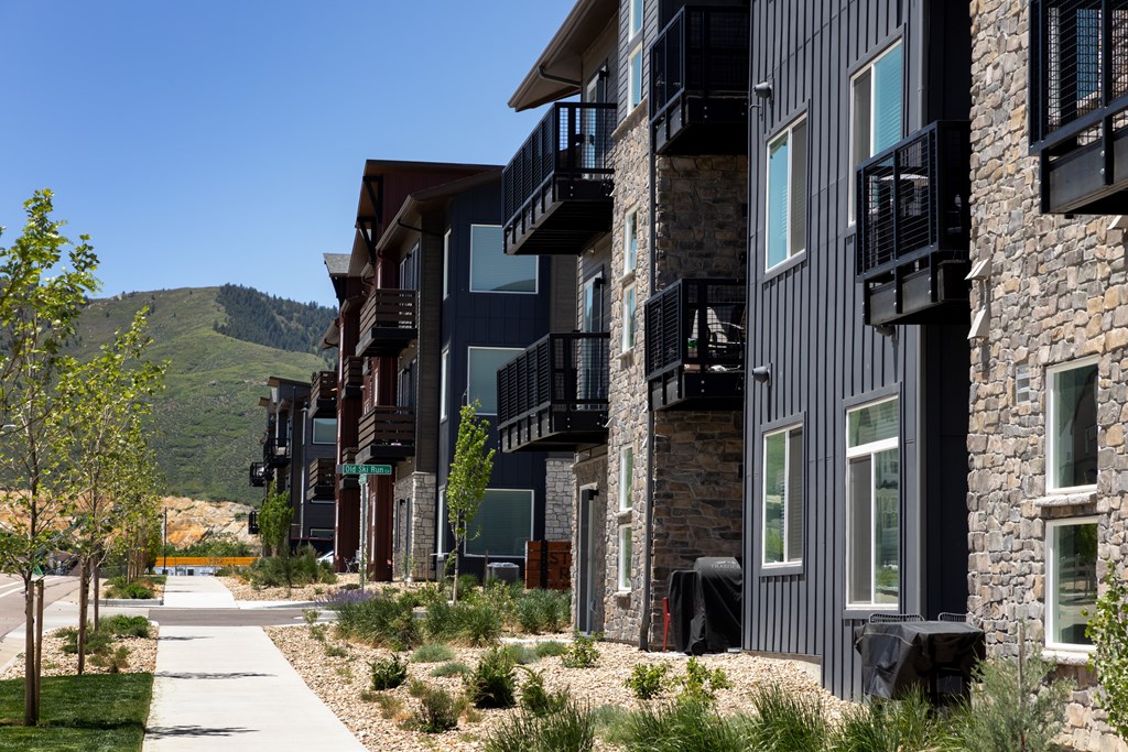 A row of modern buildings with balconies and windows.